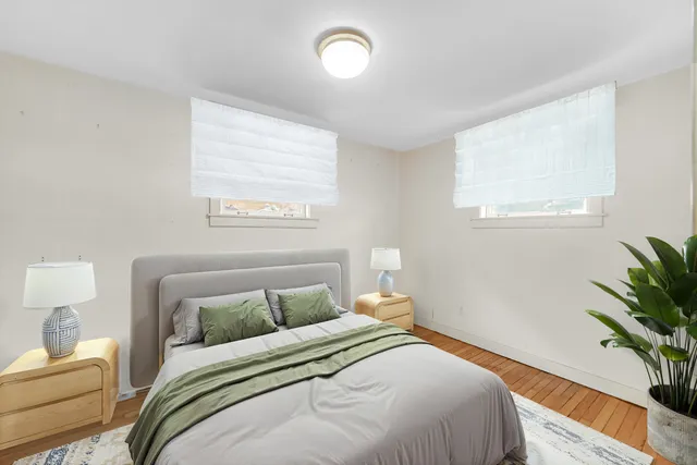 a bedroom with a bed and a potted plant