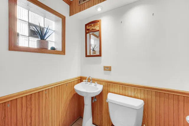 a bathroom with a sink mirror and toilet