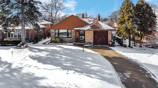 a front view of a house with yard and seating area