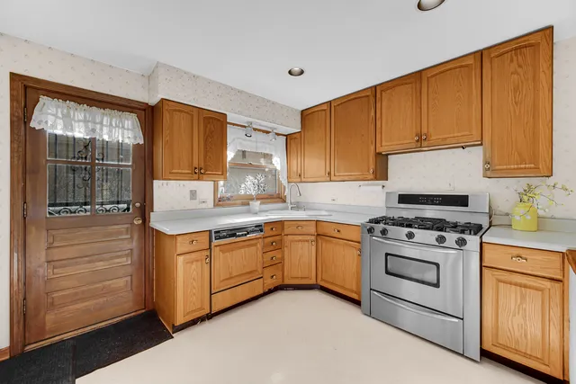 a kitchen with granite countertop cabinets stainless steel appliances and a window