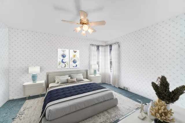 a bedroom with a bed and a painting on the wall