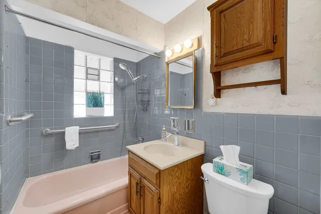 a bathroom with a sink a toilet and bathtub