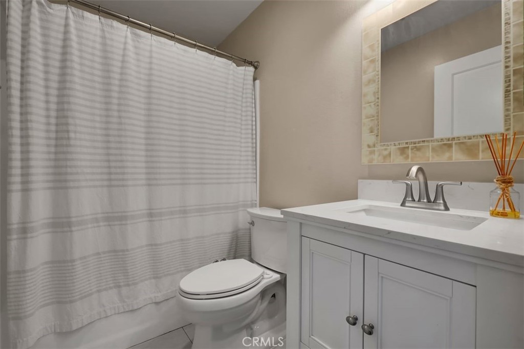 755 North East Street Anaheim, CA 92805 - Photo 15 of 31 a bathroom with a sink a toilet and mirror