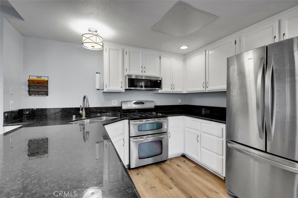 755 North East Street Anaheim, CA 92805 - Photo 20 of 31 a kitchen with stainless steel appliances a refrigerator sink and microwave