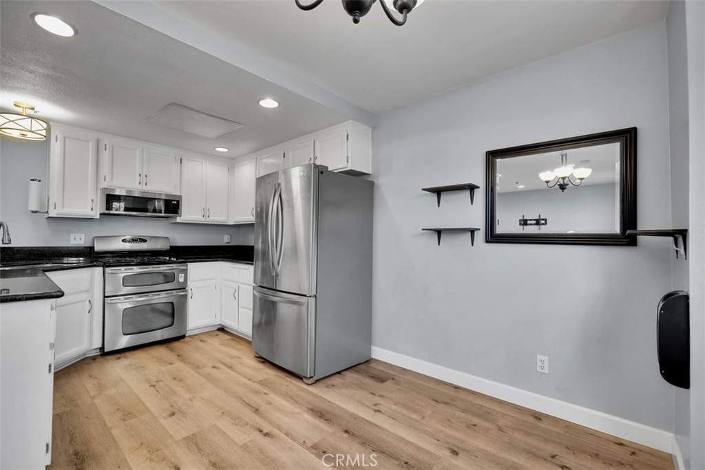 755 North East Street Anaheim, CA 92805 - Photo 22 of 31 a kitchen with a refrigerator and a stove top oven