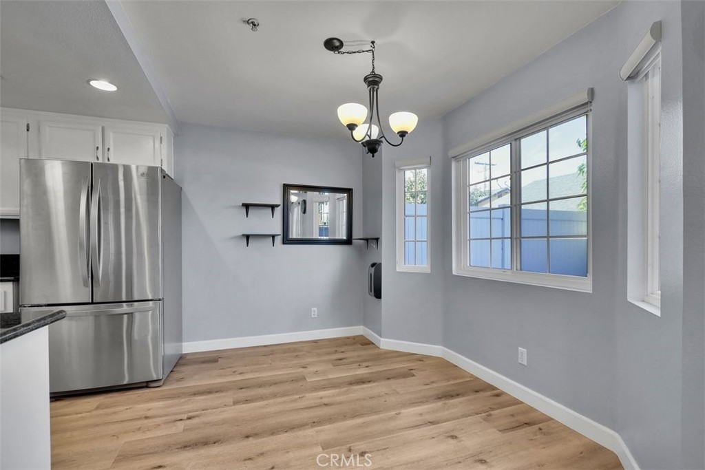 755 North East Street Anaheim, CA 92805 - Photo 23 of 31 a view of a kitchen with wooden floor and a refrigerator