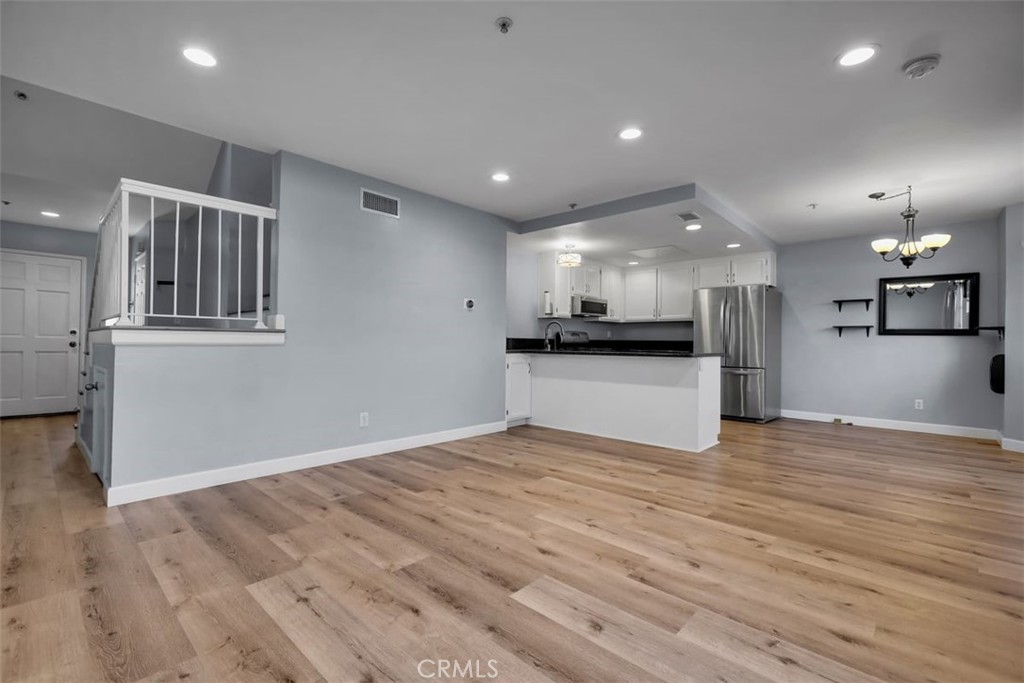 755 North East Street Anaheim, CA 92805 - Photo 25 of 31 a view of kitchen and empty room with wooden floor