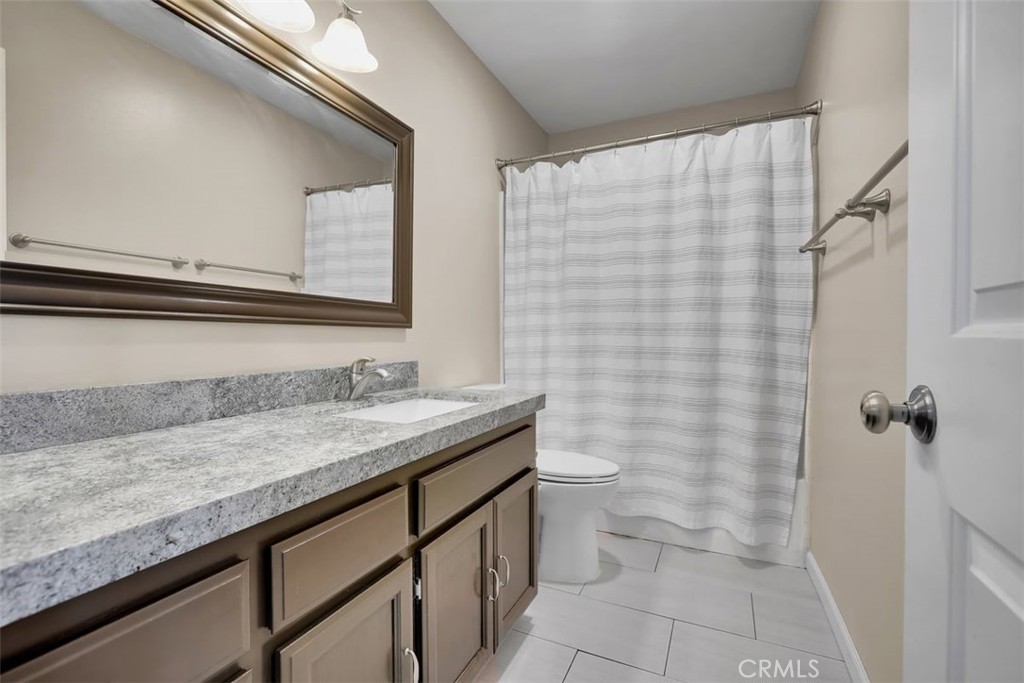755 North East Street Anaheim, CA 92805 - Photo 8 of 31 a bathroom with a granite countertop sink and a mirror