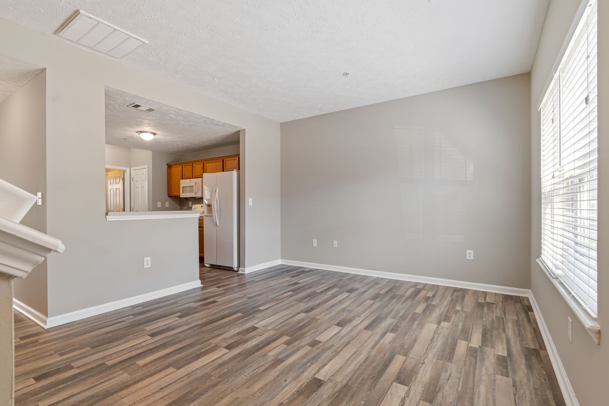 1020 Somerset Springs Drive Spring Hill, TN 37174 - Photo 2 of 13 wooden floor in an empty room with a window