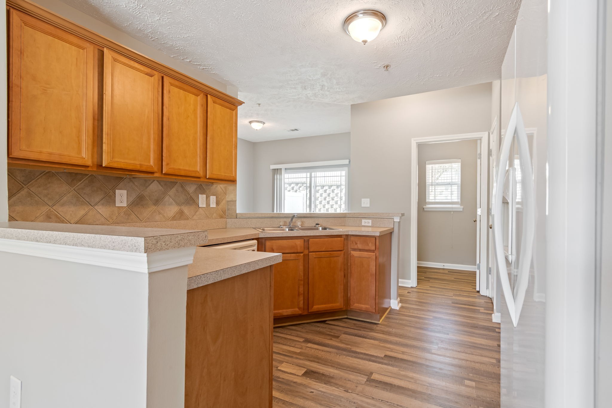 1020 Somerset Springs Drive Spring Hill, TN 37174 - Photo 4 of 13 a kitchen with stainless steel appliances granite countertop a sink a stove cabinets and wooden floor