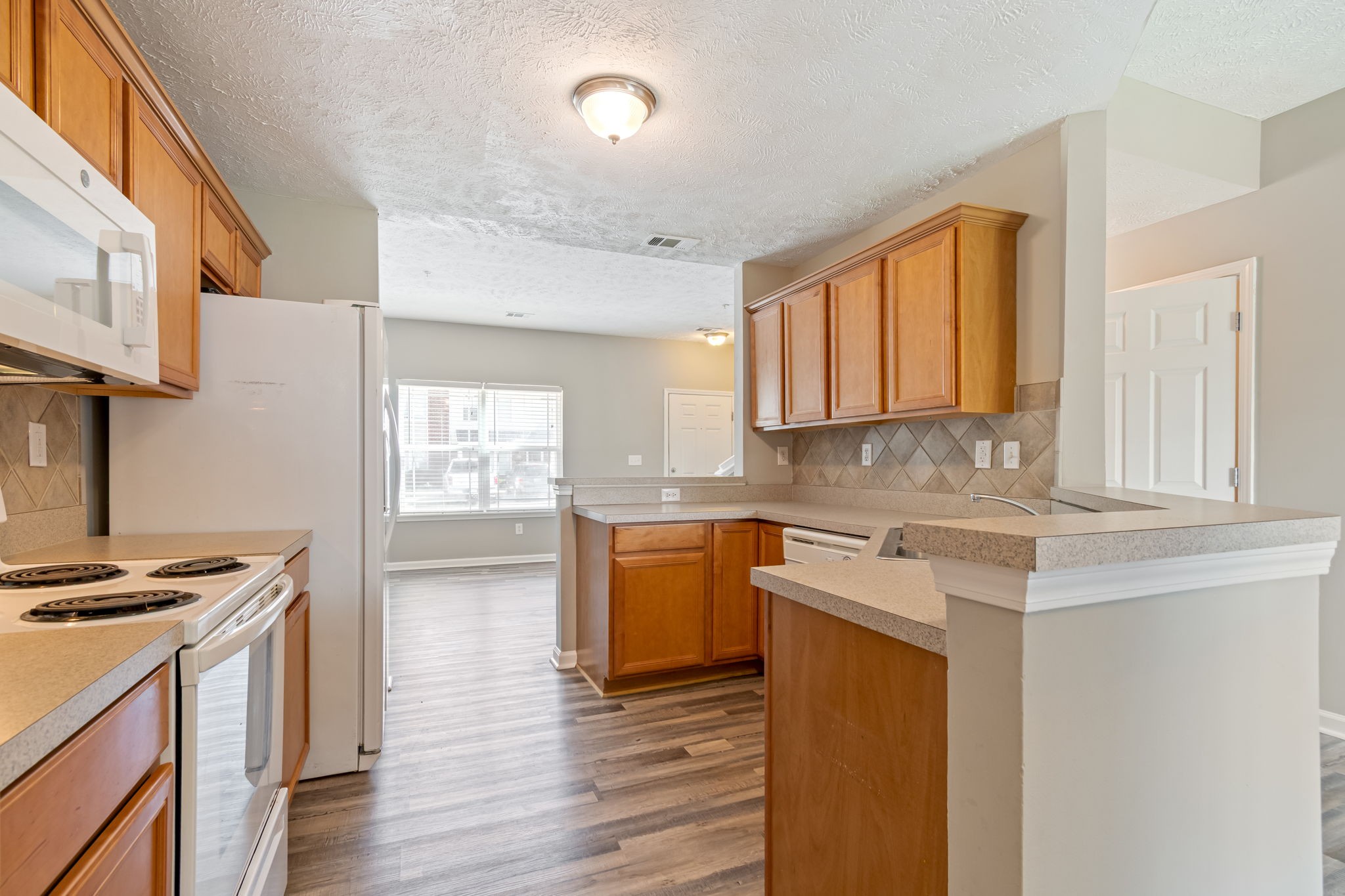 1020 Somerset Springs Drive Spring Hill, TN 37174 - Photo 5 of 13 a kitchen with stainless steel appliances granite countertop a stove a sink and a refrigerator