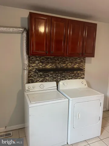 a kitchen with granite countertop a sink a stove and cabinets