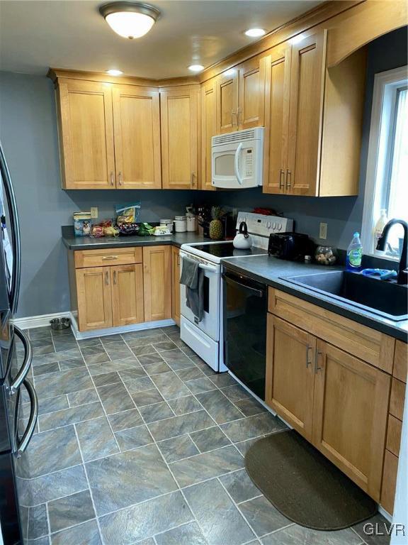535 Forrest Avenue Bethlehem, PA 18017 - Photo 5 of 16 a kitchen with stainless steel appliances granite countertop a stove a sink a microwave and cabinets