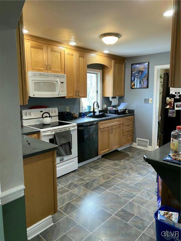 535 Forrest Avenue Bethlehem, PA 18017 - Photo 6 of 16 a kitchen with stainless steel appliances granite countertop a sink stove and refrigerator