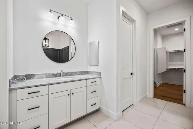 a bathroom with a granite countertop sink a toilet and bathtub