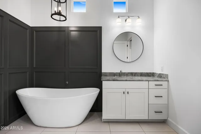 a white bath tub sitting next to a shower