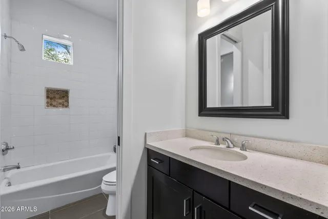 a bathroom with a sink vanity and a mirror