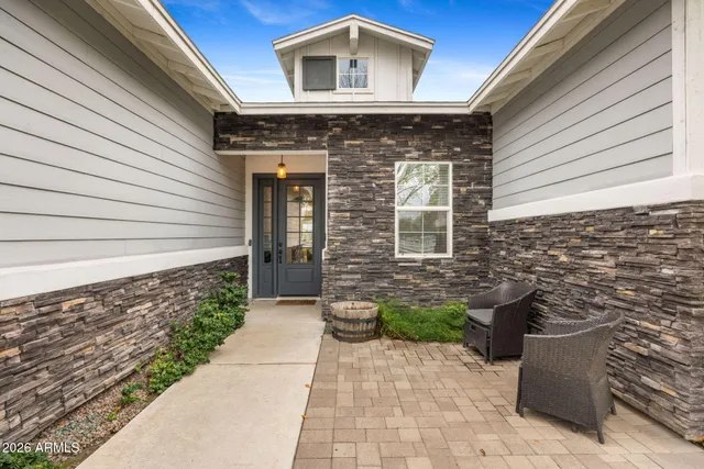 a front view of a house with a garden