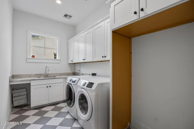 a view of an empty room with cabinet and entryway