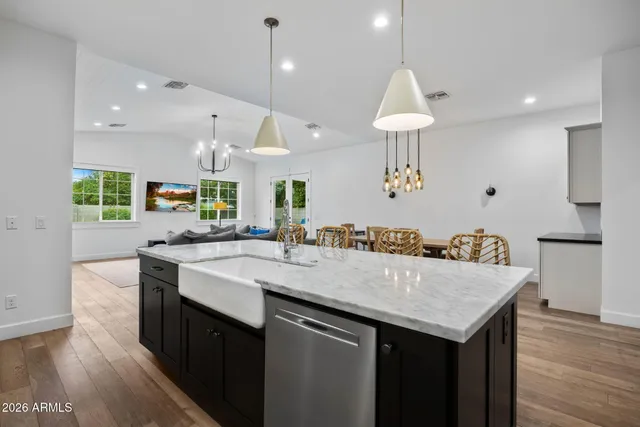 a kitchen with granite countertop a table and chairs in it