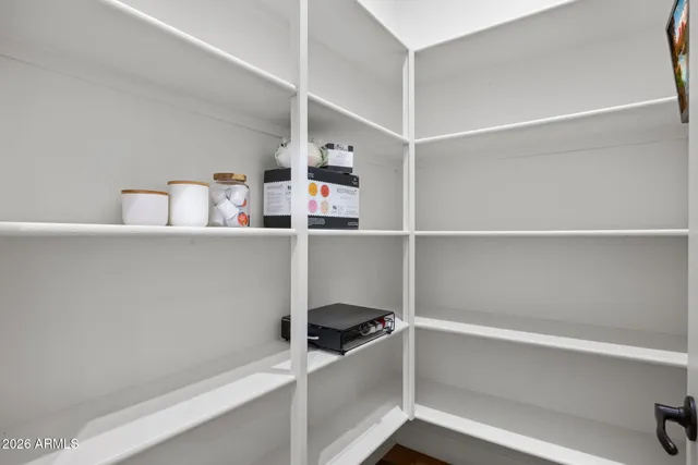 a large kitchen with a table and chairs