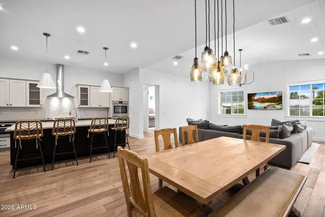 a large kitchen with a table and chairs