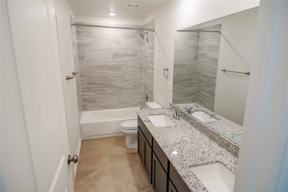 1261 Lehmann Drive, Unit A Copperas Cove, TX 76522 - Photo 10 of 18 a bathroom with a granite countertop sink toilet and shower