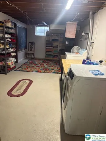 a view of a storage & utility room with two washing machine