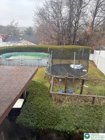 a view of a house with a yard and a street