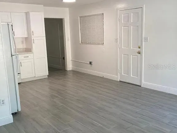 an empty room with wooden floor and white doors
