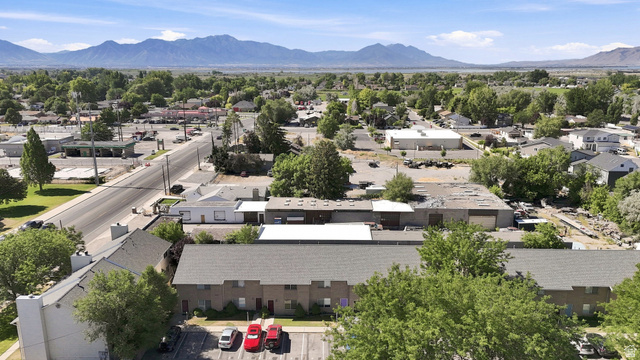 203 North Geneva Road, Unit 10 Provo, UT 84601 - Photo 24 of 30 Expansive aerial perspective showcasing a townscape with verdant trees and distant mountains
