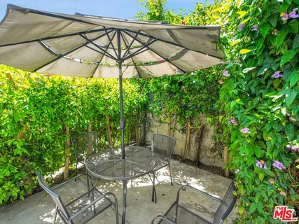 a patio with a yard table and chairs
