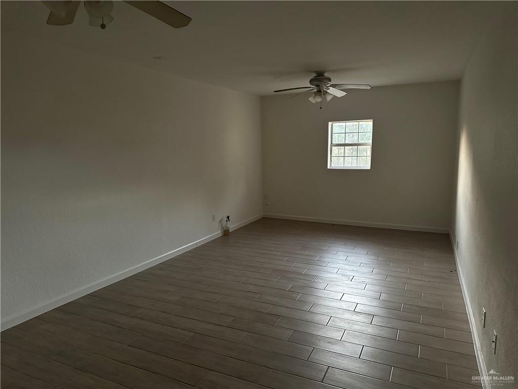 12517 North Taylor Road Mission, TX 78573 - Photo 16 of 22 an empty room with wooden floor and windows
