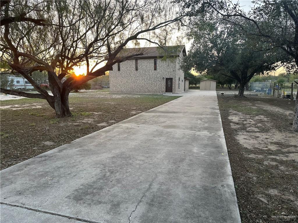 12517 North Taylor Road Mission, TX 78573 - Photo 2 of 22 a white house that has a tree in front of it