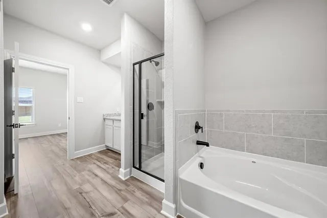 a bathroom with a bathtub and a shower