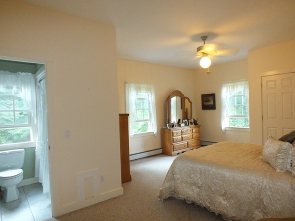 64 Wood Hill Road Monson, MA 01057 - Photo 13 of 30 a bedroom with a bed and a chandelier