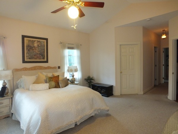 64 Wood Hill Road Monson, MA 01057 - Photo 16 of 30 a bedroom with a bed and a chandelier
