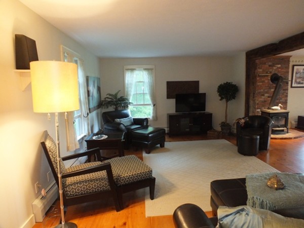 64 Wood Hill Road Monson, MA 01057 - Photo 3 of 30 a living room with furniture a lamp and a flat screen tv