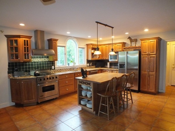 64 Wood Hill Road Monson, MA 01057 - Photo 5 of 30 a kitchen with stainless steel appliances granite countertop a stove a sink a refrigerator and chairs