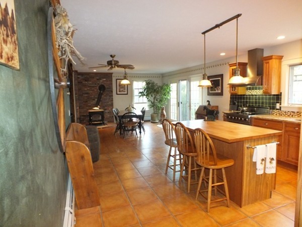 64 Wood Hill Road Monson, MA 01057 - Photo 7 of 30 a dining room with furniture a large window and a chandelier