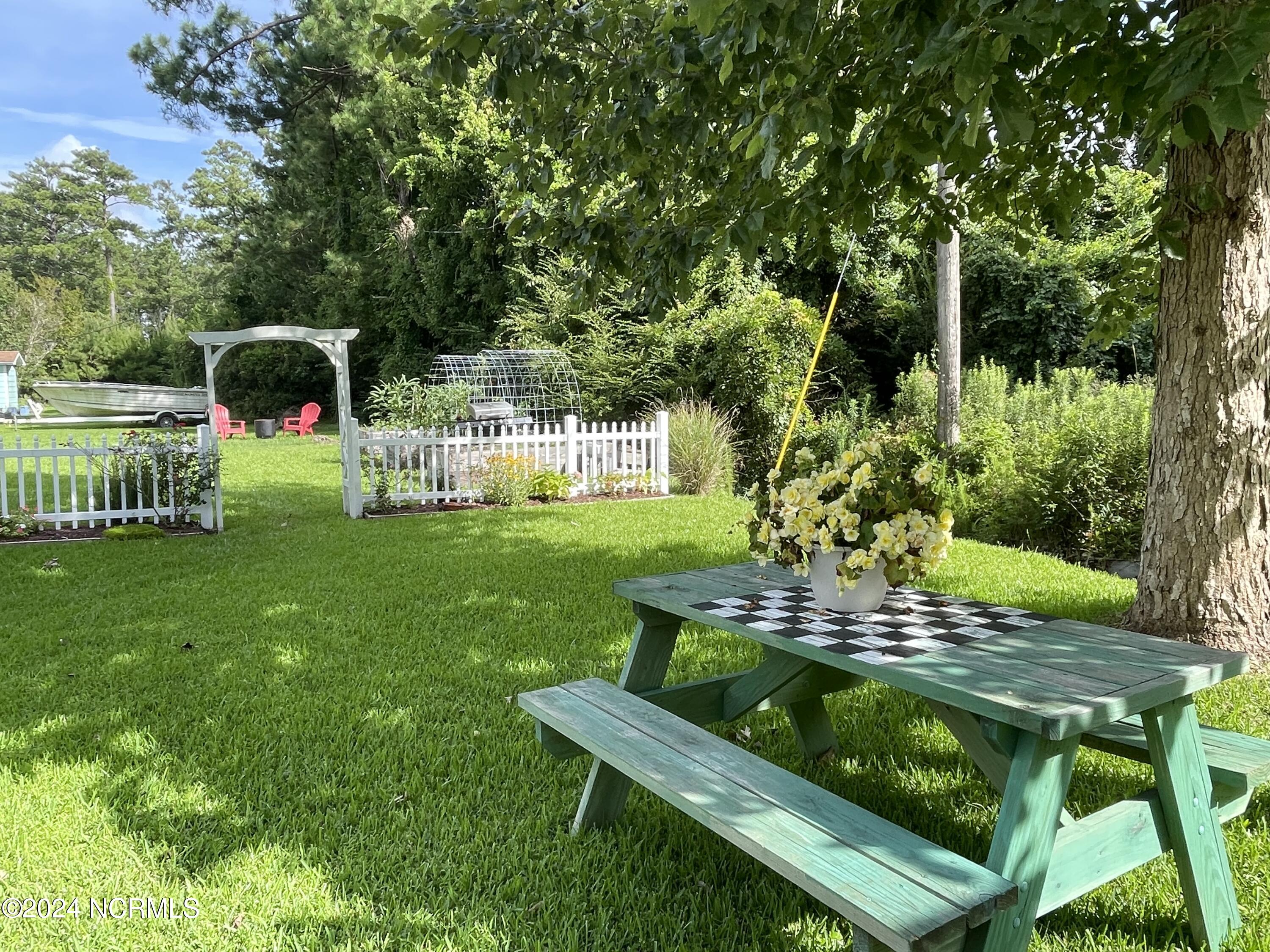 263 Core Creek Road Beaufort, NC 28516 - Photo 44 of 55 picket fence and trellis make this backyard a happy place to work in the garden