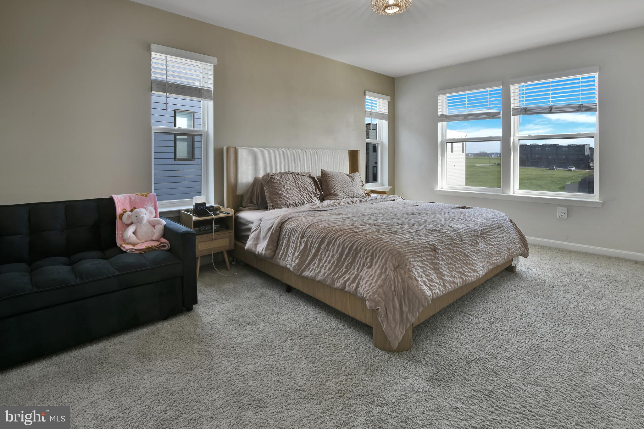 457 Tiller Street Frederick, MD 21701 - Photo 14 of 25 a spacious bedroom with a bed couch and windows