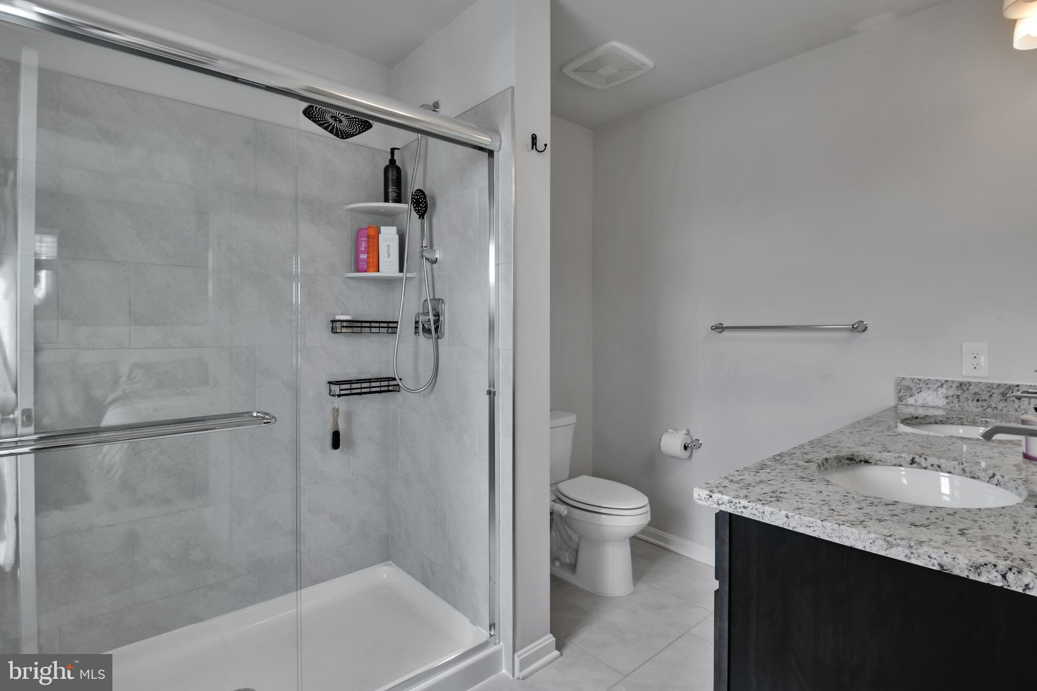 457 Tiller Street Frederick, MD 21701 - Photo 15 of 25 a bathroom with a granite countertop sink toilet and shower