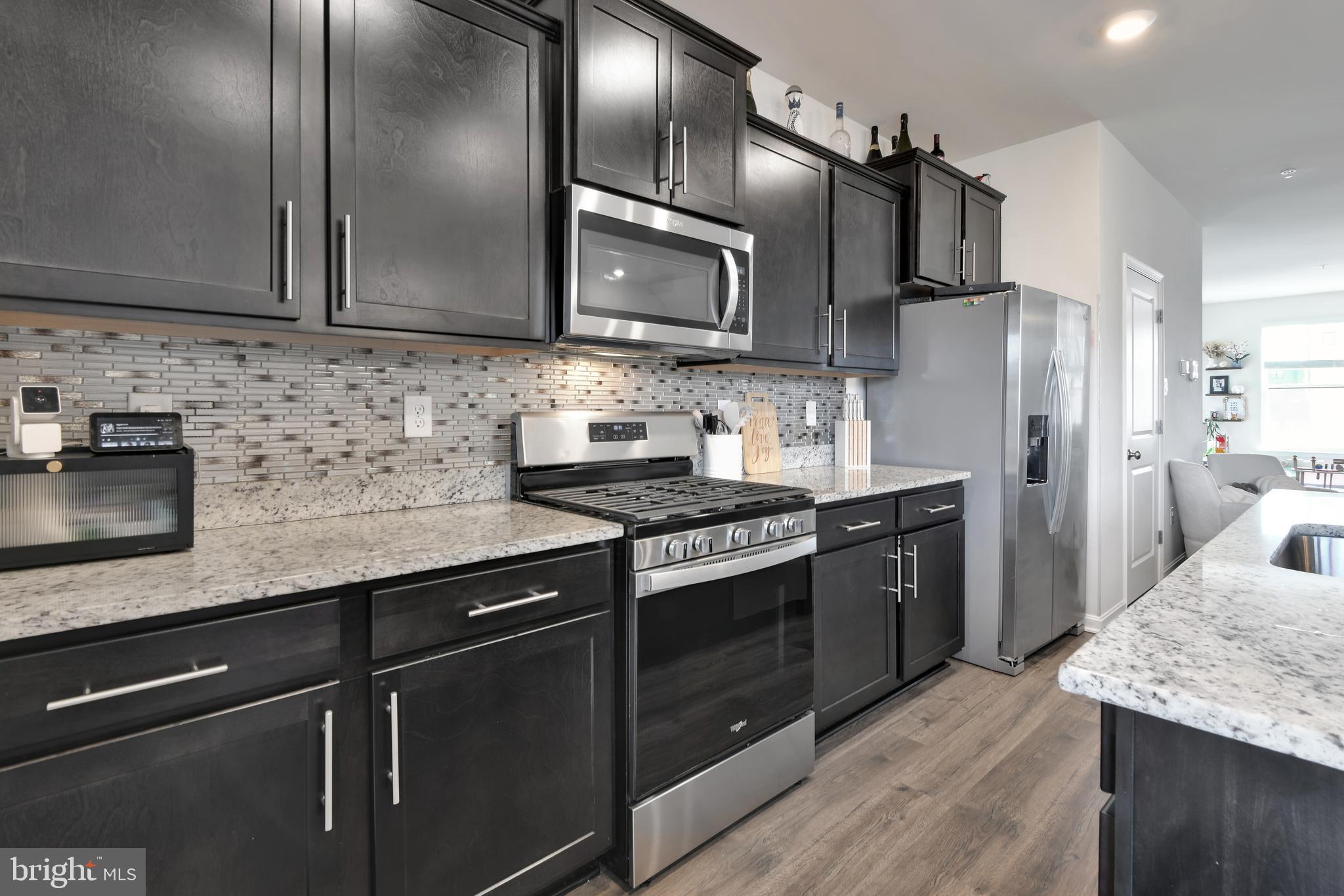457 Tiller Street Frederick, MD 21701 - Photo 4 of 25 a kitchen with stainless steel appliances granite countertop a sink stove and refrigerator
