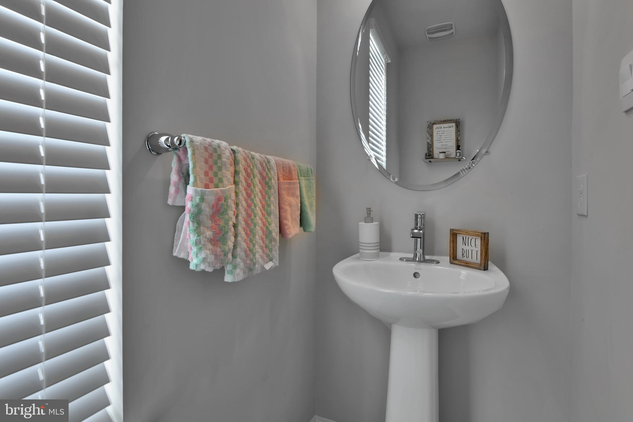 457 Tiller Street Frederick, MD 21701 - Photo 7 of 25 a bathroom with a sink and a mirror