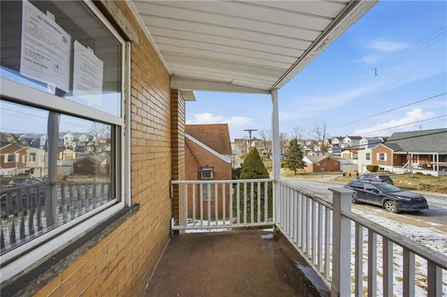 a view of a porch with wooden floor