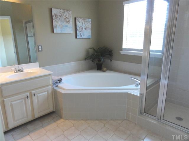 7412 Wisconsin Court Raleigh, NC 27615 - Photo 6 of 13 The Master Bath has dual vanities, Garden Tub, separate Shower, and a Water Closet.