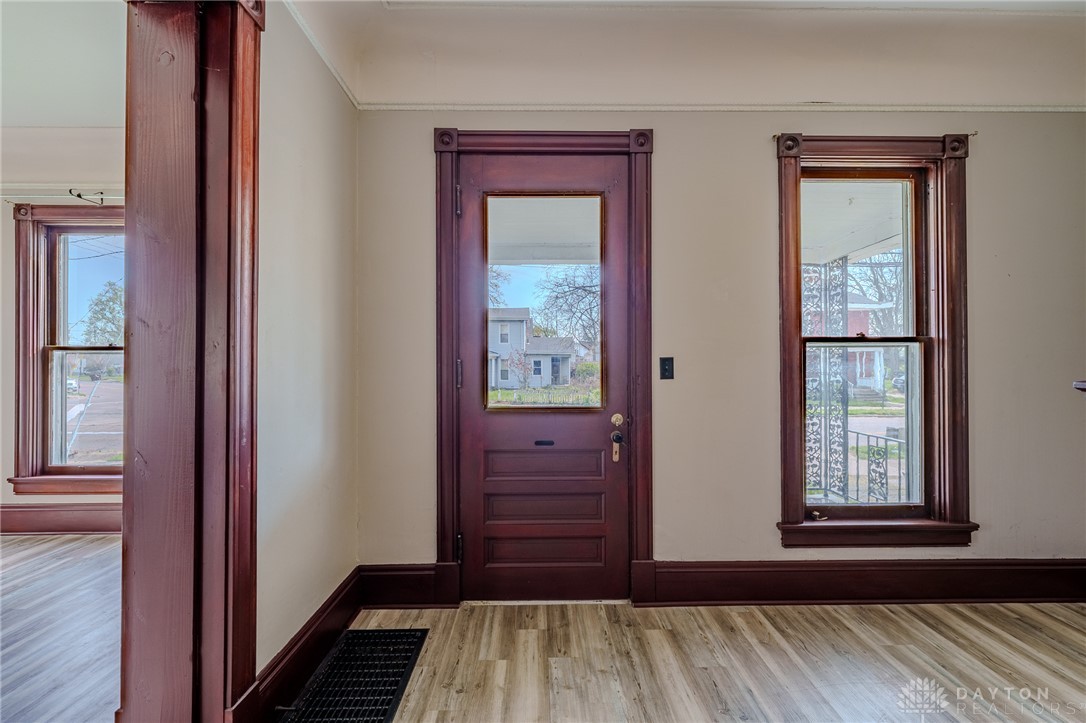 308 Yankee Road Middletown, OH 45044 - Photo 9 of 47 This inviting entryway showcases a classic wooden door and charming windows with detailed trim.