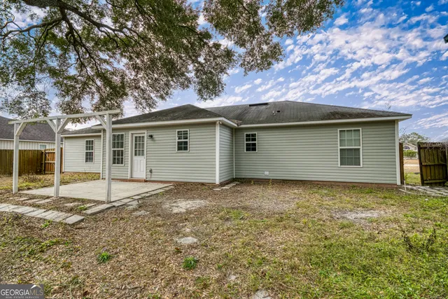 a view of a house with a tree in the background