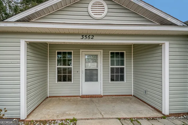 a living room with furniture a table and a window